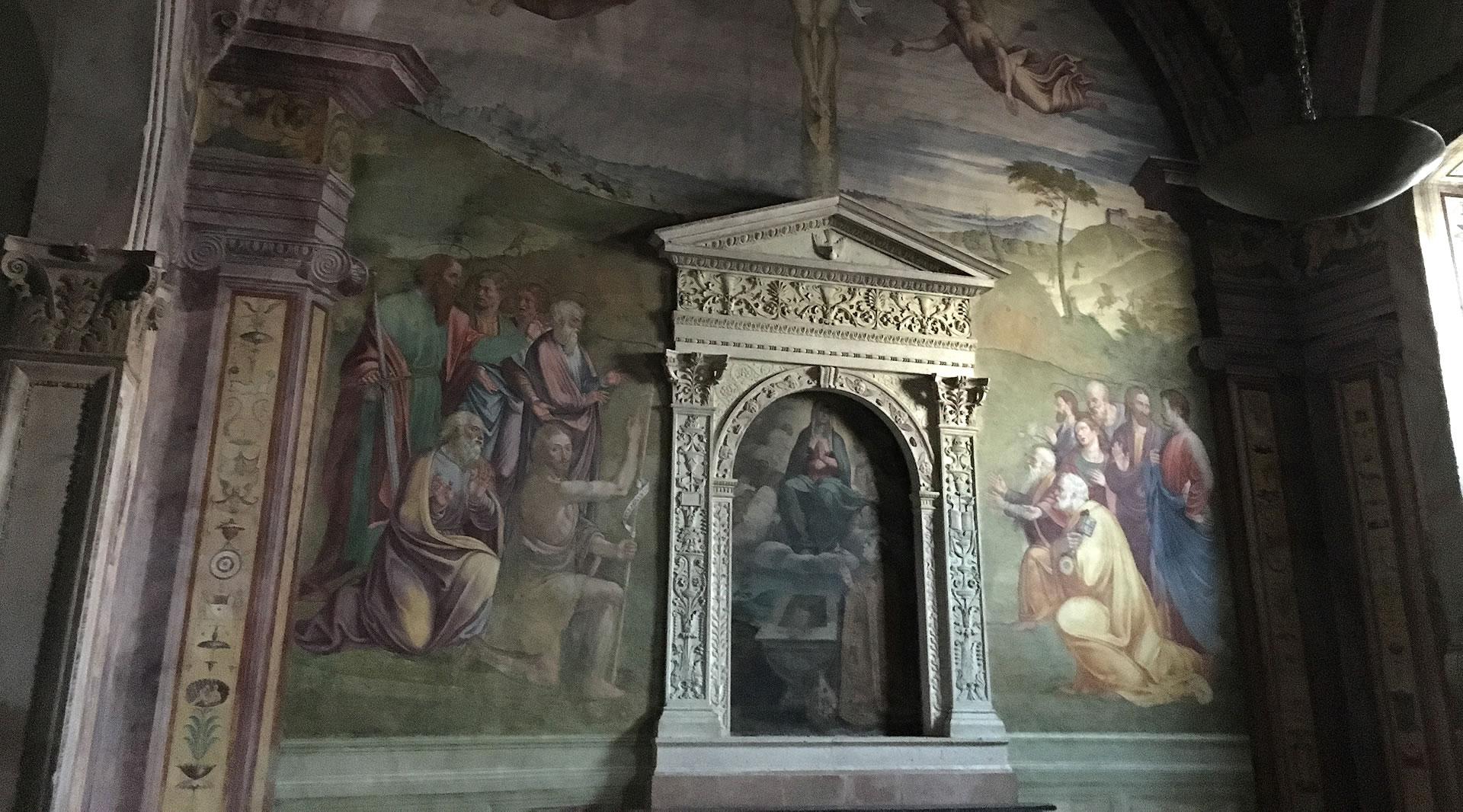 Frescoed chapel in Spoleto Cathedral, with biblical scenes, Renaissance decorations, and a sculpted marble aedicule.
