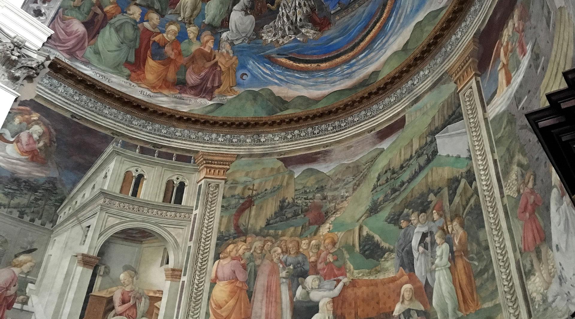 Renaissance frescoes in the apse of Spoleto Cathedral, featuring detailed biblical scenes, painted architecture, and rolling landscapes.
