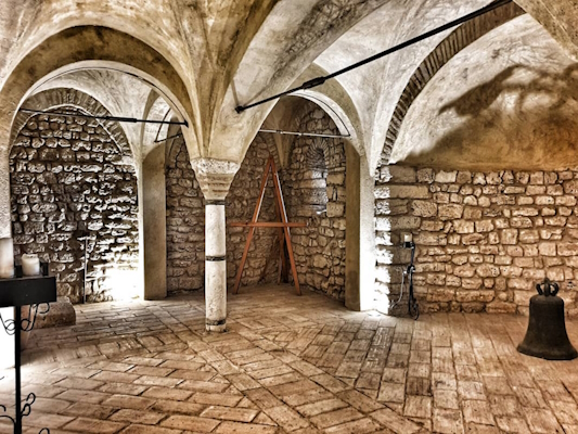 Underground crypt of the Church of Santa Pudenziana with ribbed vaults supported by travertine columns.