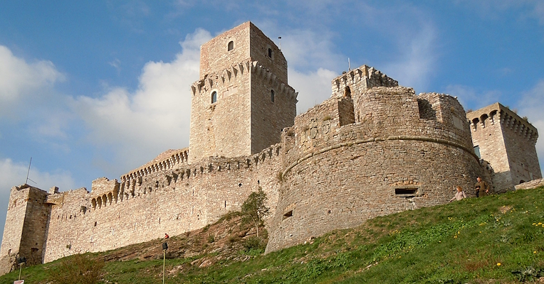 Vue en contre-plongée de l’imposante forteresse de l’Albornoz d’Assise, avec à droite le donjon central et l’imposant bastion circulaire.