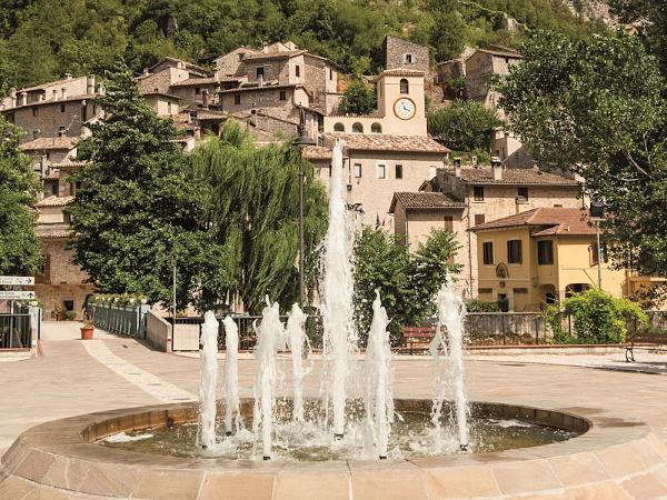 The village of Scheggino with the sloping castle resting on the hillside dominating the historic centre in the background