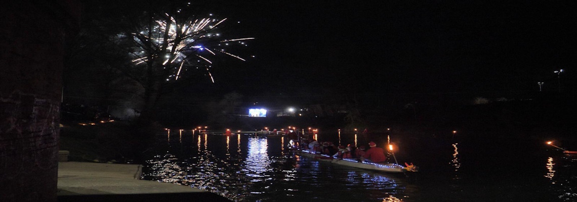 Panoramic view of the Tiber River during the descent of the Father Christmases in canoes and simultaneous fireworks display - Città di Castello