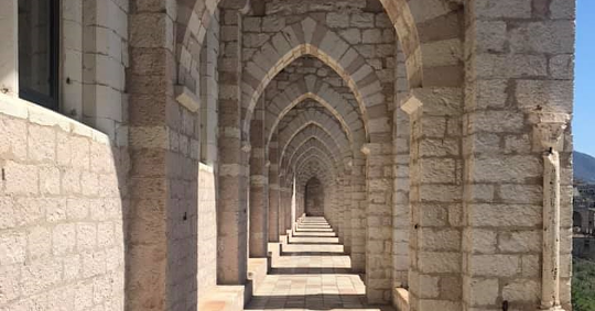  View of the portico of the Sacro Convento of Assisi made of Subasio stone 